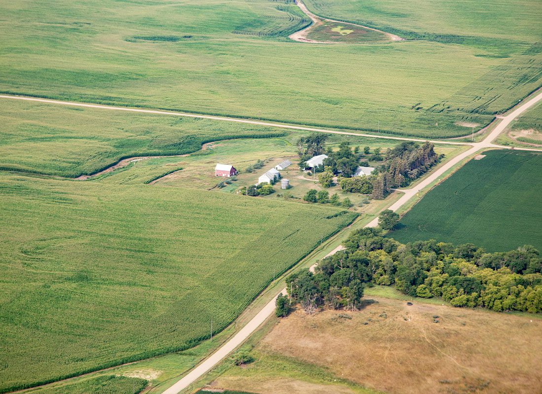 About Our Agency - Aerial View of Fields Full of Crops and Farm Houses in Rural South Dakota